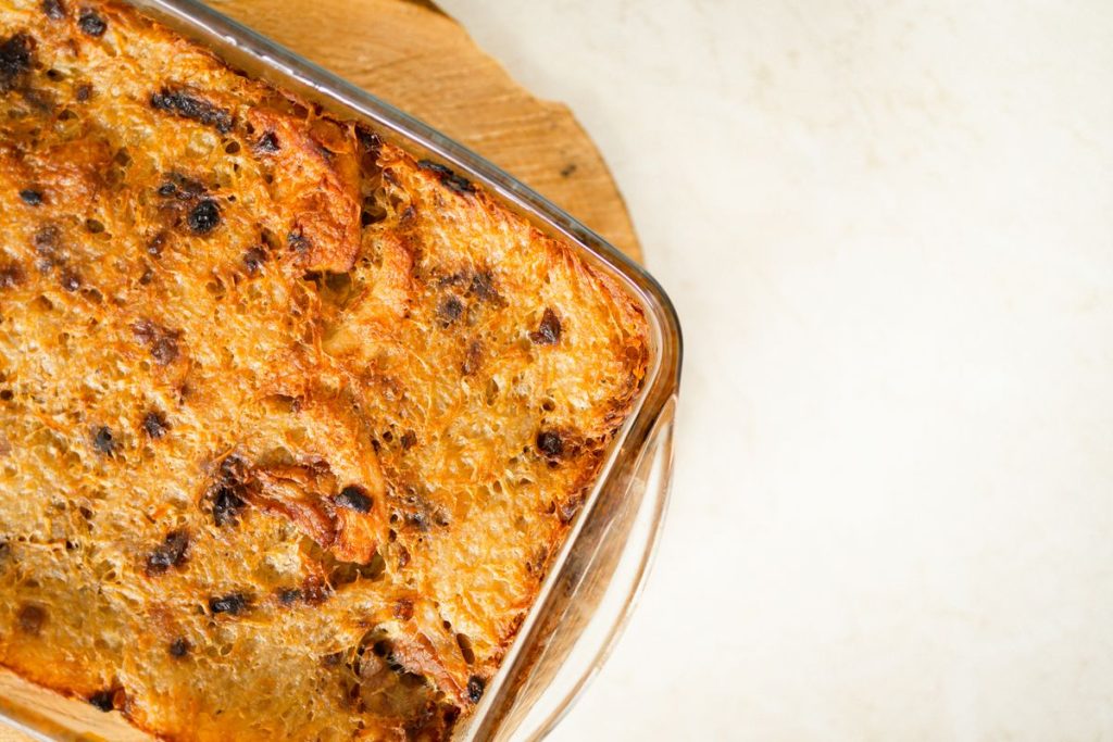 Golden baked bread pudding casserole fresh from the oven, overhead view