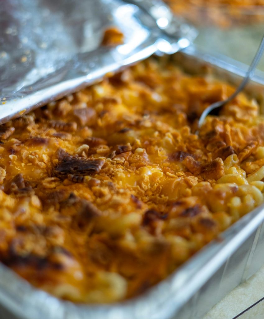 Baked mac and cheese with a golden crumb topping in a pan