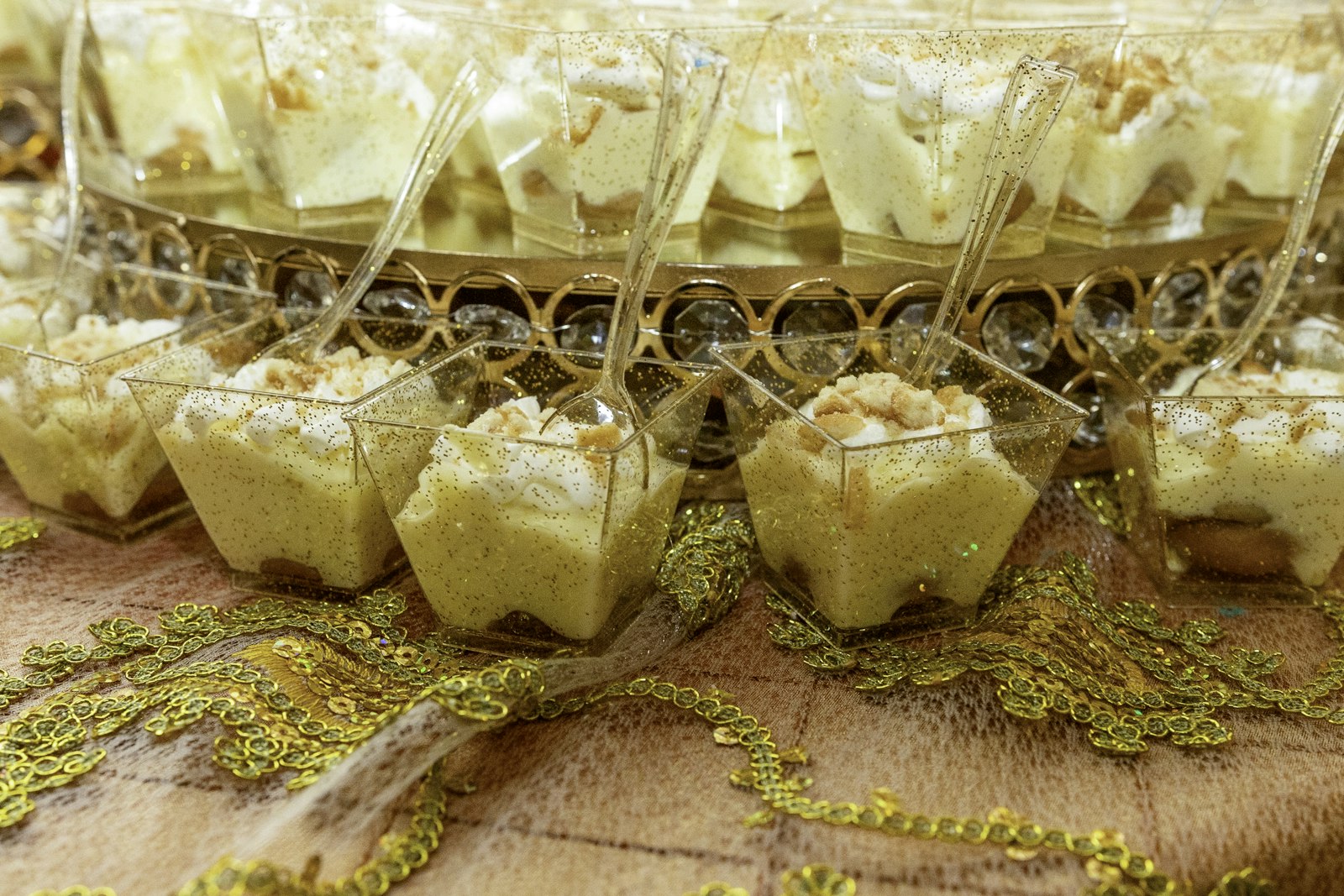 Banana pudding cups topped with whipped cream and wafer crumbs