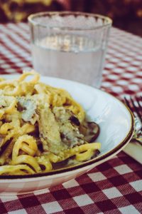Creamy mushroom pasta with parmesan in a white bowl