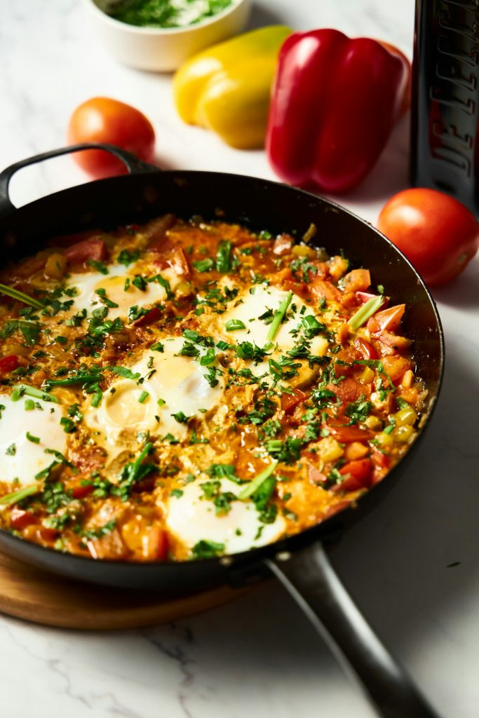 Easy shakshuka recipe with eggs in tomato sauce in a skillet