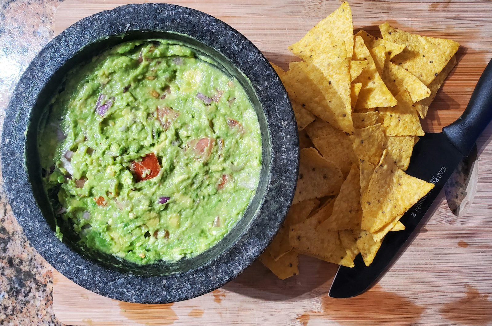 Homemade guacamole in a molcajete with tortilla chips