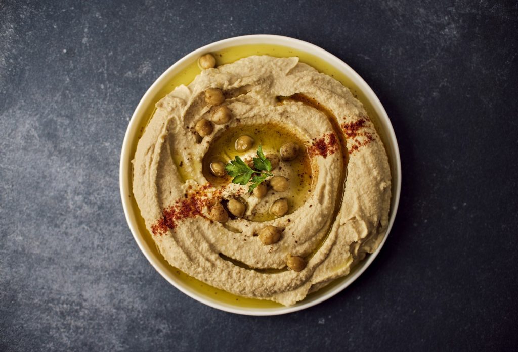 Homemade hummus with olive oil, chickpeas and paprika in a bowl