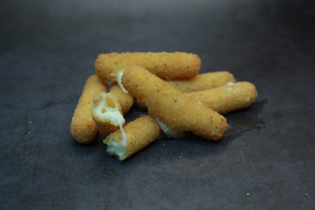 Homemade mozzarella sticks with melted cheese pull