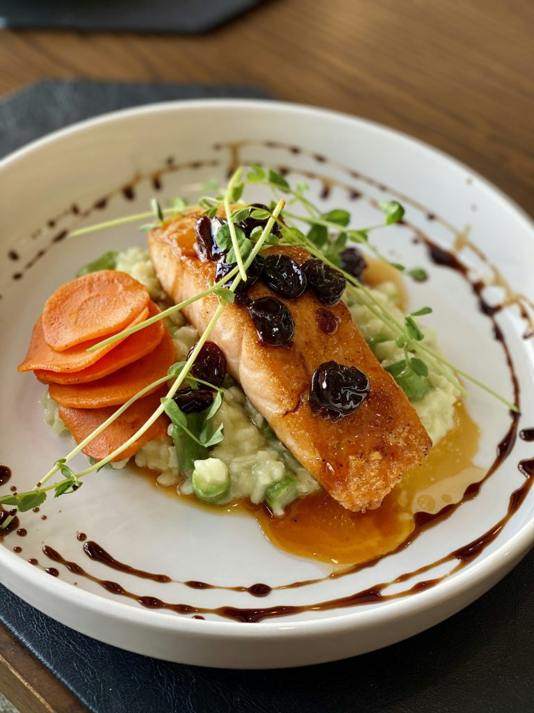 Honey garlic salmon fillet with a glossy glaze on a white plate