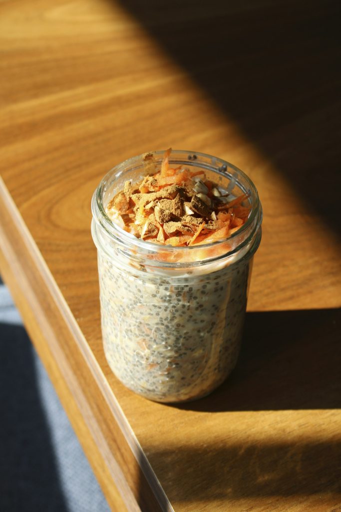Peanut butter overnight oats in a glass jar on a wooden table