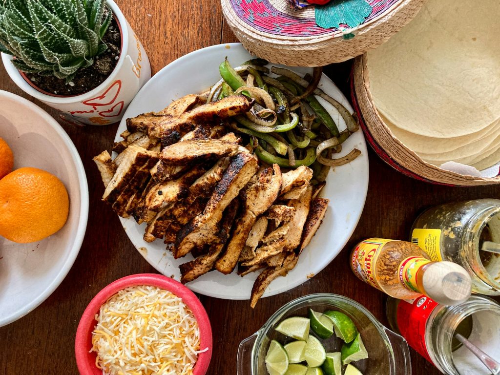 Sheet pan chicken fajitas with peppers, onions, tortillas and limes