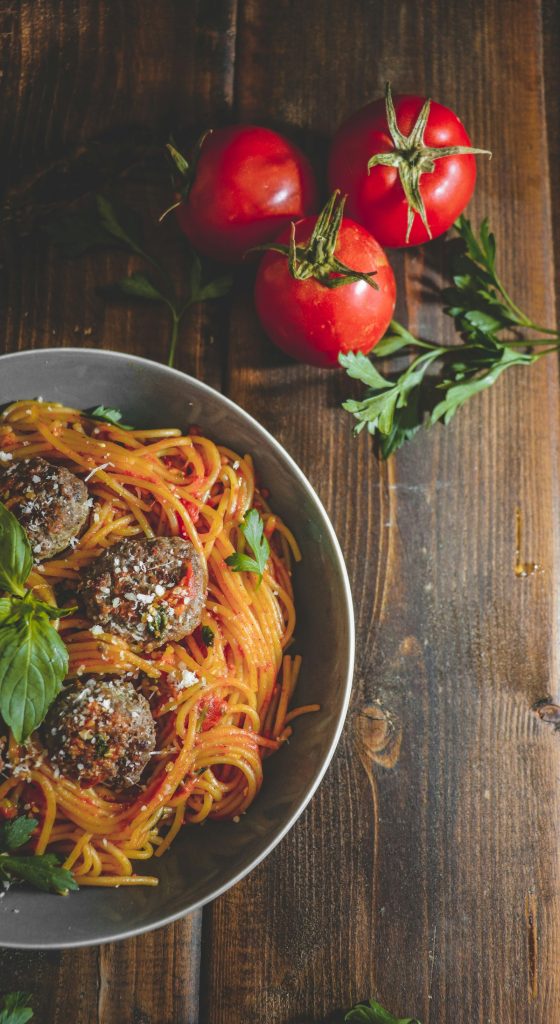 Spaghetti and meatballs in tomato sauce with basil and parmesan