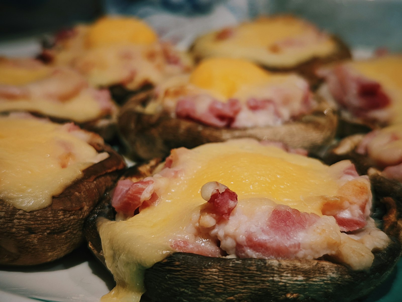 Cheesy stuffed mushrooms baked until golden on a plate